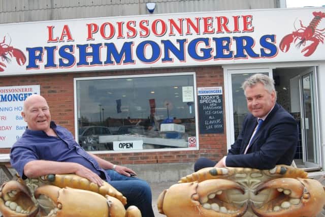 Jim Partridge and Tim Loughton outside Jim's wet fish shop on Fisherman's Wharf, where direct fish sales are important. PICTURE: JOHN PERIAM