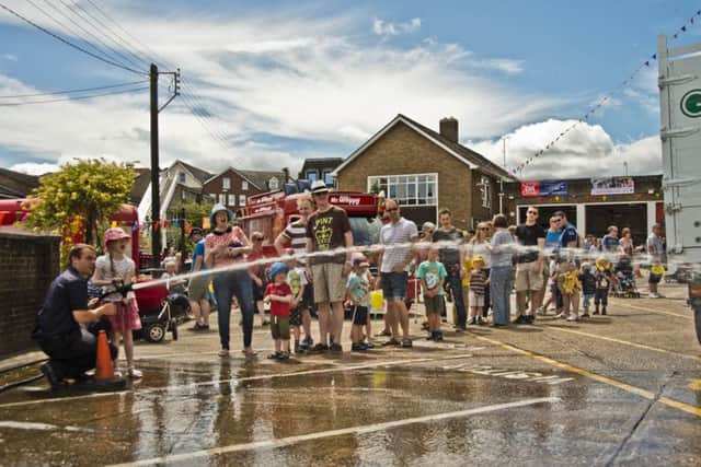 Members of the public got to try using a hose. Picture: Eddie Howland