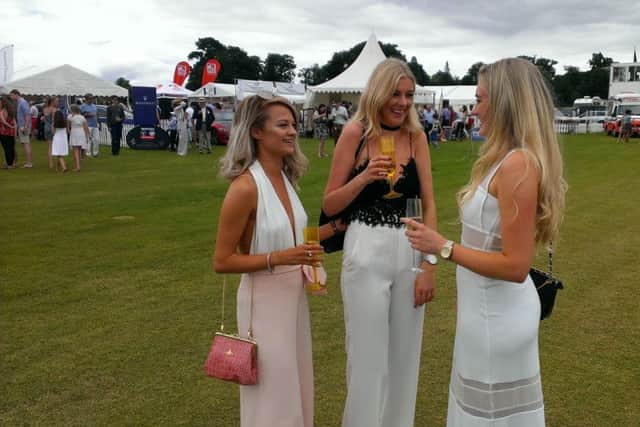 Spectators enjoying a glass of bubbly at the Gold Cup Final