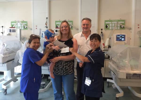 Victoria and Paul Warrington with baby Harry and the neonatal staff.