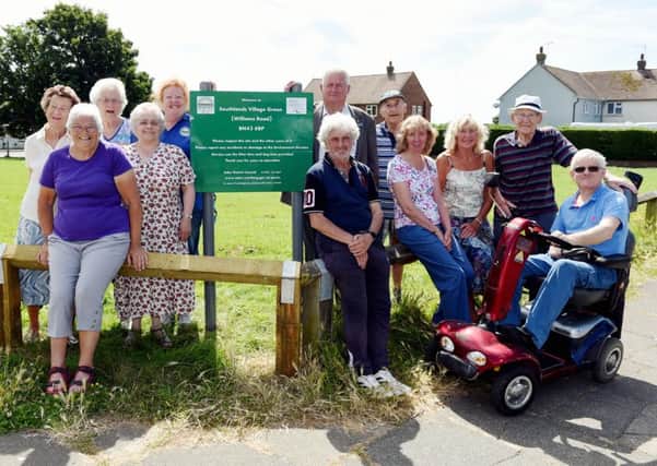 Unveiling the new Southlands Village Green sign are Southlanders Community Group chairman Ann Martin  and Adur councillor Paul Graysmark, watched by residents from the Williams Road area. Picture: Liz Pearce LP1600219