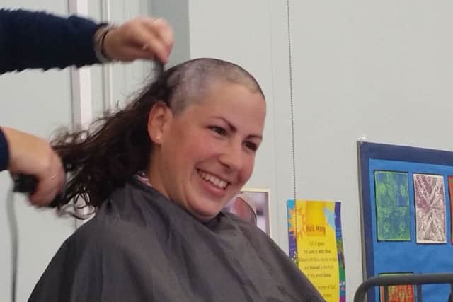 Nuria Molina-Rivas having her head shaved for charity