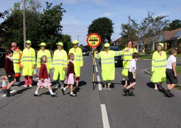 Some of the new school crossing patrol officers with pupils from Newick C of E Primary School. Photo: Ron Hill SUS-160719-143142001