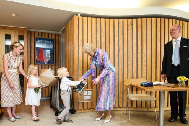 HRH Princess Alexandra being presented with flowers and an catalogue for the Gallerys Christopher Wood exhibition by Walter and EsmÃ© Judd, children of Harriet Judd, head of publishing at Chichester's Pallant House Gallery. Photo by Jason Hedges Â© Pallant House Gallery.