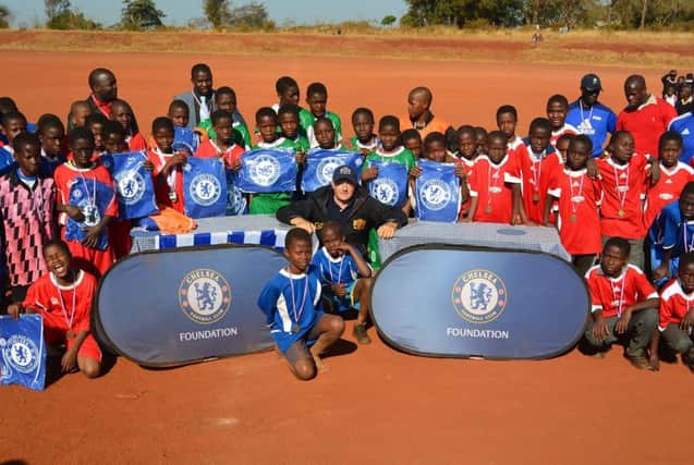 Matt Mooney from Chelsea with some of the children taking part in the Hearts and Smiles Foundation Program. SUS-160725-135050001