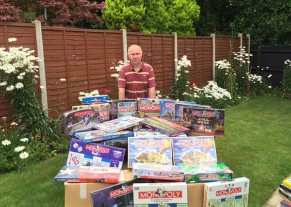 Neil Scallan and some of his huge Monopoly collection SUS-160722-142836001