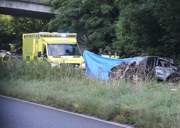 Emergency services at the crash scene on the A24. Photo by Eddie Mitchell SUS-160724-093325001