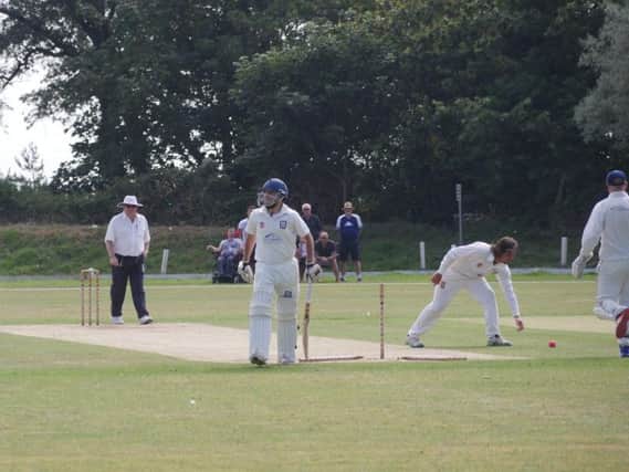 Hastings Priory bowler Freddie Hulbert splatters the stumps in the final over of the Bexhill innings.