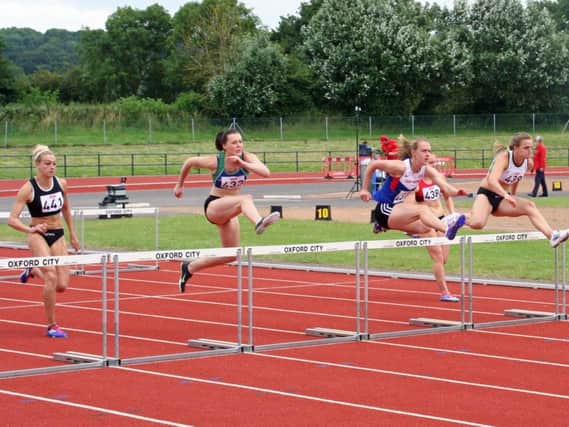 Elise Lovell, centre, leads the way in the 100m hurdles