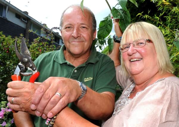 Sue Wickstead found her wedding ring - which she lost four years ago - while gardening. Pictured with her husband Geoff Riddick and the buddleia she was pruning when she lost her ring. Pic Steve Robards  SR1622673 SUS-160725-175534001