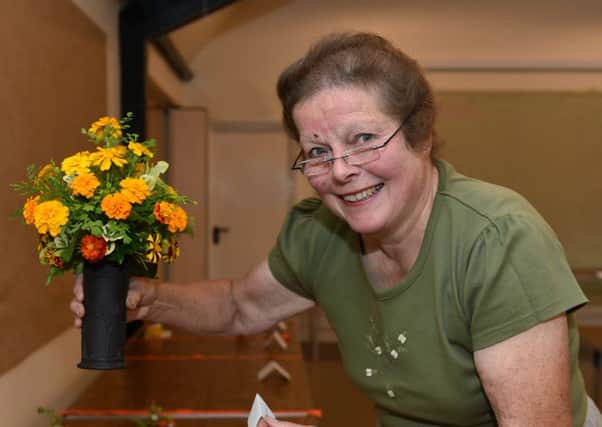 Society chairman Hannah Stanley setting up at Stedham with Iping Horticultural Society's annual flower show. Pictures: Liz Pearce LP1600250