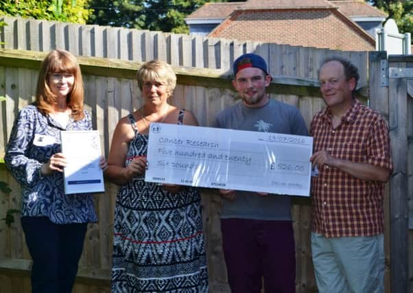 Yvonne OConnor, Cancer Research UK's area manager, far left, receives the cheque from student Callum Wadey