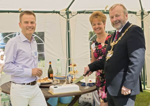 Worthing mayor Sean McDonald cuts the anniversary cake with Jan Olsen and Sarah Cooper-Olsen