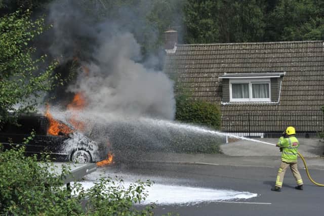 Fire fighters tackle a car fire in Battle Road, St Leonards SUS-160728-142240002