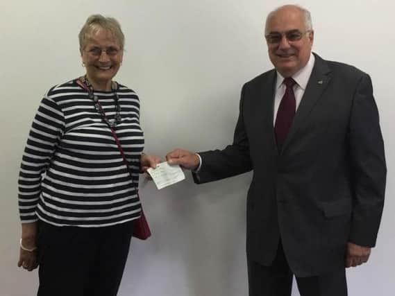 Pippa Campbell accepts a 500 donation from Lewes Rotary's Ian Martin