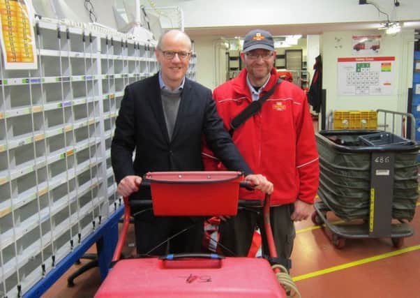 MP Nick Gibb with postman Adrian Ford in the Royal Mail sorting office in Bognor Regis SUS-150712-100805001