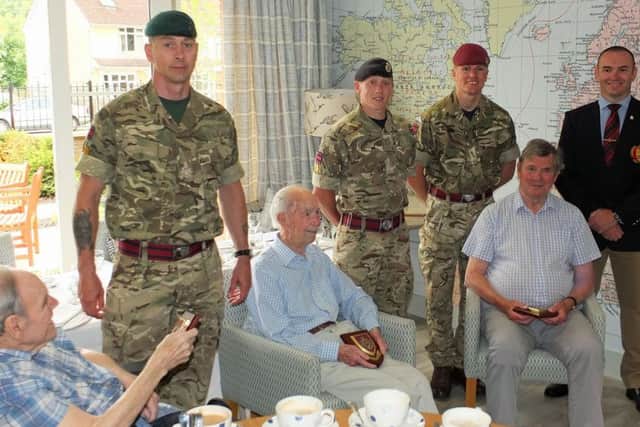 Ian Lye Grant, John Benstead and Jack Lumley receive regimental plaques from the Royal Engineers