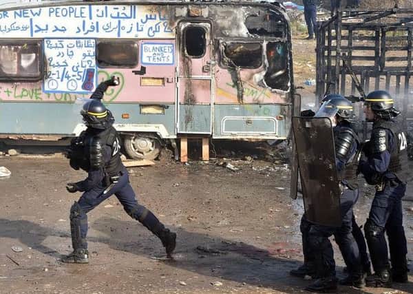 French police throwing tear gas on a regular visit to the camp