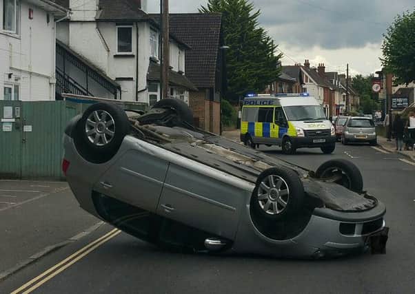 Car on roof in Three Bridges Road. Photo by Crawley Police.