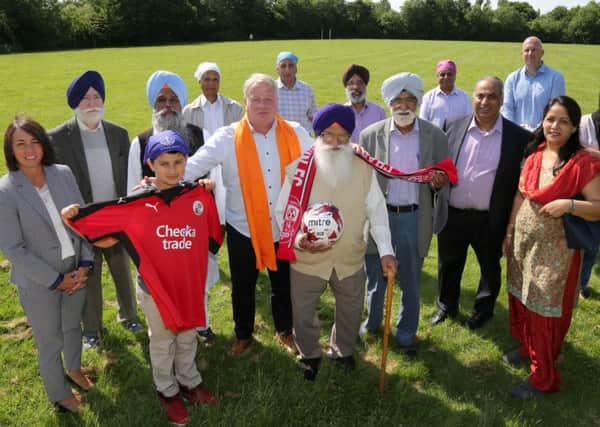 Members of the Sikh community with Crawley Town Head Coach Dermot Drummy, assistant Matt Gray and Operations Director Kelly Derham at the launch of the partnership at the Sikh Gurdwara and Community Sports Centre in Ifield Green. Picture: James Boardman SUS-160806-144541001