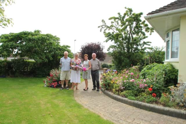 Joint winners Tony and Sheila Payne, of Cissbury Avenue, receive their prize