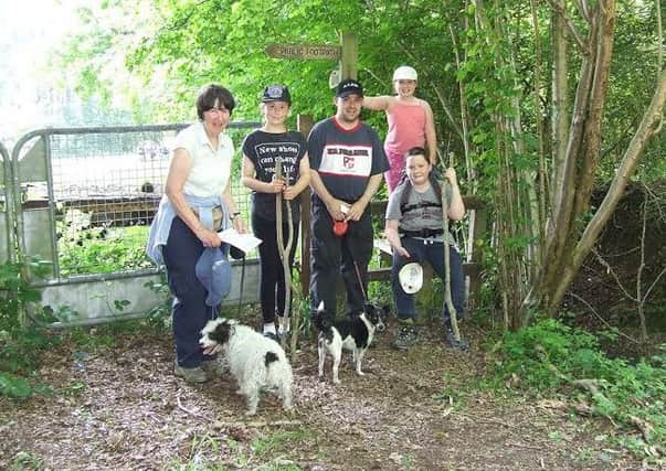 A family group of walkers posing for a photograph as they make their way back to Loxwood during the Wey & Arun Canal Trust's 2016 sponsored walk, the Poddle