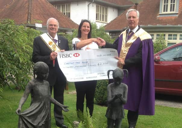 Paul Rose, head of the Masonic Order in Sussex, and his deputy Bernard Marchant present the Â£2,500 cheque to Caroline Roberts-Quigley, community fundraiser for Chestnut Tree House children's hospice