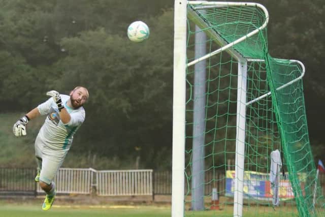 Westfield's goalkeeper can't prevent Steve Watt scoring for Hastings United during the first half. Picture courtesy Scott White