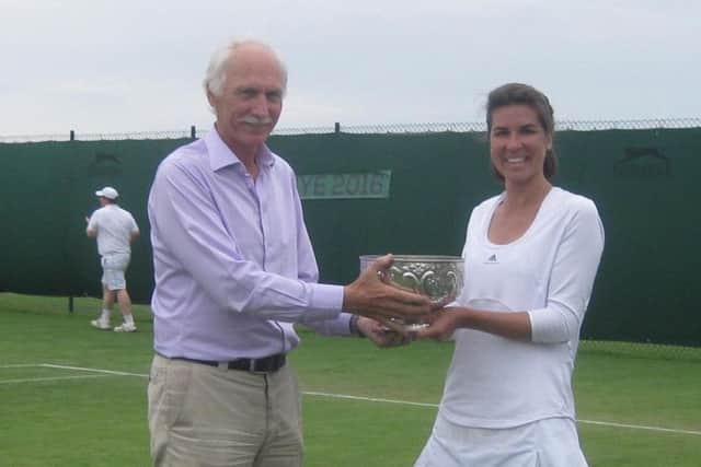 Philippa Coates holds the ladies' singles trophy with Jonathan Jempson, the clubs chairman