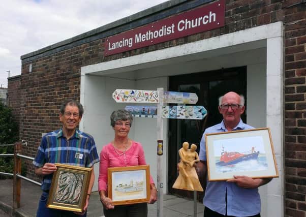 Hugh Garrett, who organised a signpost called Time Lines for this years exhibition, is pictured, left, with exhibition organiser Eve Wilson and art club secretary Doug Arternon