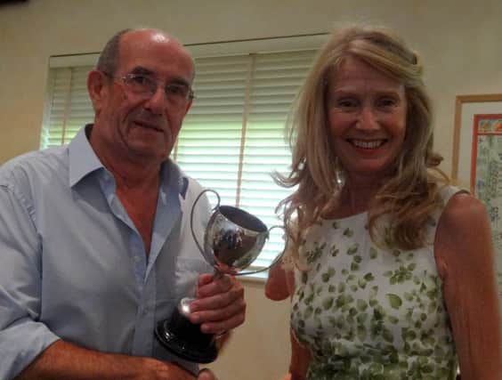 John Etherington receiving one of his cups from society member Caroline Nelson SUS-160908-111259001