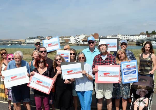 Residence campaign to to raise legal funds to fight riparian ownership of the Adur Tidal Walls Scheme. 

Pictured are house boat and house residence with Revd Jess Jermain (center).
Shoreham, West Sussex. 

Reporter: Oli Poole
Picture : Liz Pearce

16/08/2016
LP1600577 SUS-160816-153215008