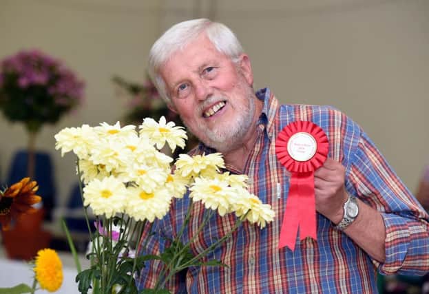 Bruce Button won best  in show with his three stem spray of chrysanthemums. Pictures: Liz Pearce LP1600482