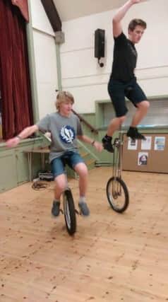 Duncan Codd and Jake Smith uni-cycling in Fernhurst village hall