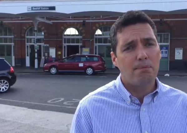 MP Huw Merriman outside Bexhill Railway Station, screenshot from his rail diary video