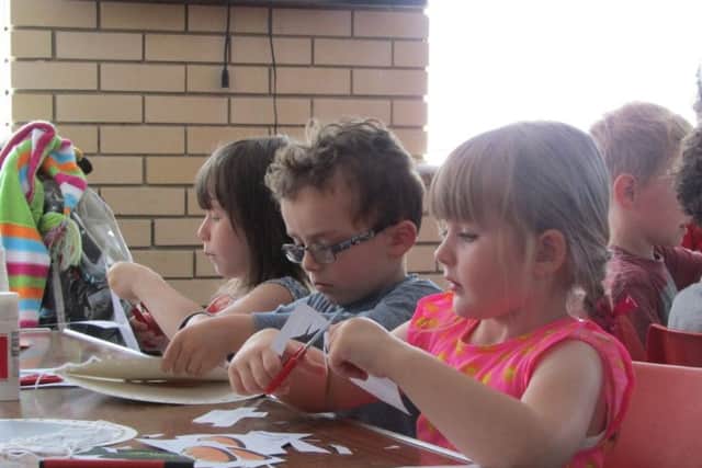 Children doing crafts at the Holiday Bible Club