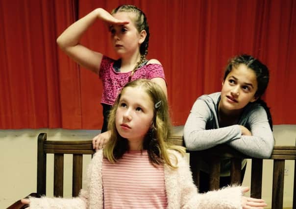 The Annies: Emily Wheatley (understudy, on the left), Harriet Douglas (sitting on bench) and Cassie Philpott. Picture by Chris Dale