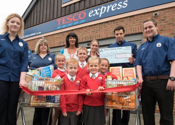 Ark Little Ridge Primary Academy pupils cut the ribbon to reopen the nearby Tesco Express with Amy Jennery, Lesley Smith, Dan Fitzhugh and Jonny Miller from the store. SUS-161208-112738001