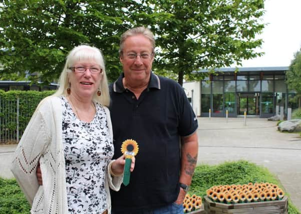 Carol and Nick Ballinger visit Martin's sunflower at St Barnabas House hospice