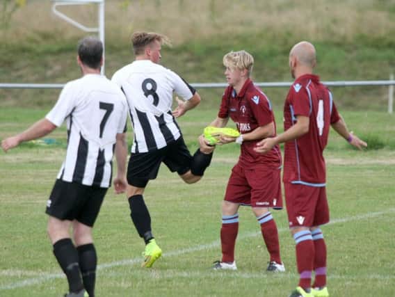 Little Common midfielder Cam Burgon gets to grips with a St Francis Rangers opponent. Picture by Derek Martin