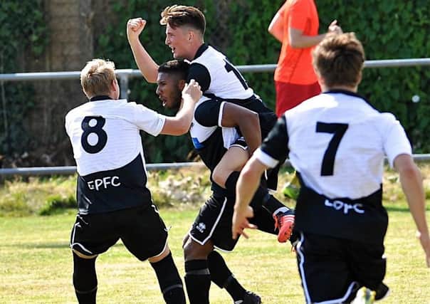 Hayden Hunter is mobbed by his team-mates after netting against Lingfield on Saturday. Picture: Stephen Goodger