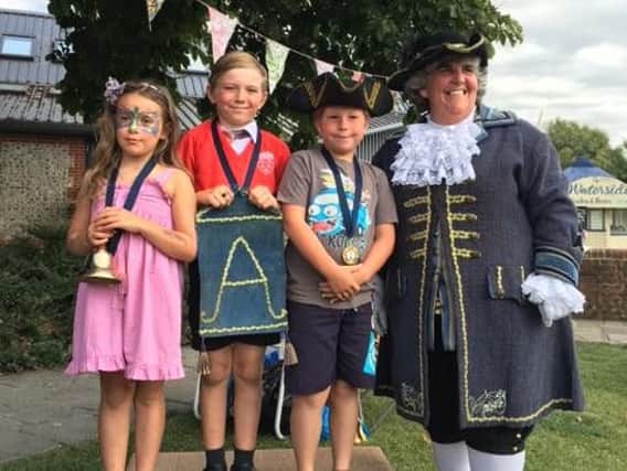 Arundel town crier Angela Standing with youth town crier finalists Isabella Binstead, Toby Sugden and Finn Richardson