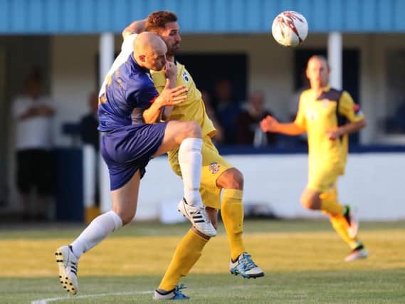 Hastings United forward Jay May tries to hold off a Herne Bay opponent. Picture courtesy Scott White
