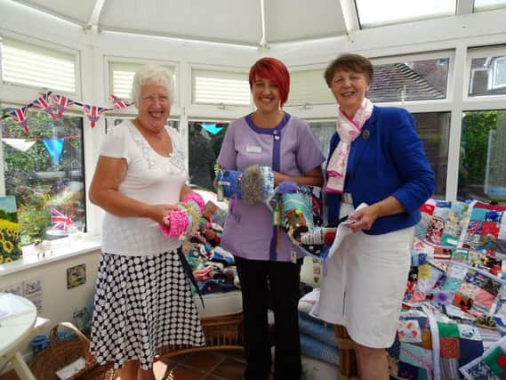 Sheila Partridge, who masterminded the project, and Alison Merriman, President, handing over the muffs and blankets to Nikki at their recent garden party