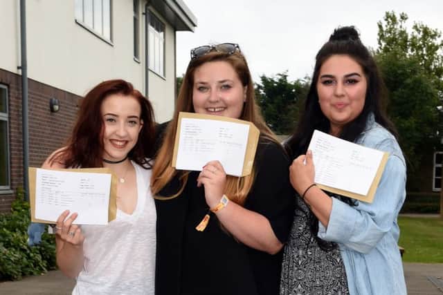 School Students celebrate their exam results at Angmering School. Pictured are L-R Georgia Spight (17), Lucy Perks (18) and Katie Franklin (18). Picture : Liz Pearce