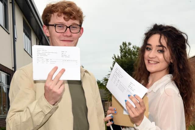 Students celebrate their exam results at Angmering School. Pictured are Jamie Baker (19) and Amber Farrent (19) Picture : Liz Pearce