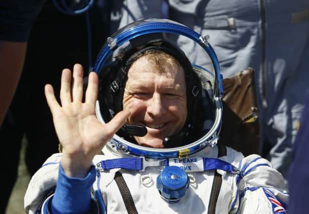 Member of the International Space Station (ISS) crew Britain's Tim Peake waves after landing near the town of Dzhezkazgan, Kazakhstan, Saturday, June 18, 2016. A three-person crew from the International Space Station has landed safely in the sun-drenched steppes of Kazakhstan. (Shamil Zhumatov/Pool Photo via AP) KAZAKHSTAN_Peake_114980.JPG