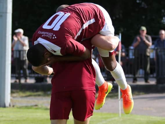 Hastings United striker Jack Harris is carried off by the club's strength and conditioning coach Harrison Grant after injuring his ankle last weekend.