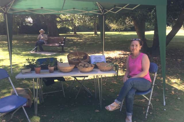 Support worker Anna with organic vegetables for sale