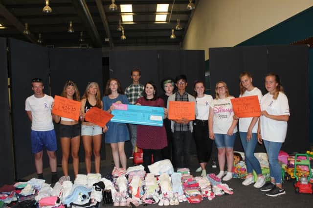 The team with all their donations to be given to Refuge SUS-160819-155335001